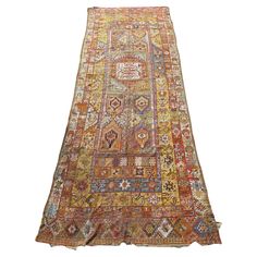 an antique persian rug with multicolored colors and designs on the bottom, it is laying