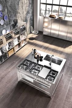 a modern kitchen with stainless steel appliances and wood flooring is featured in this image