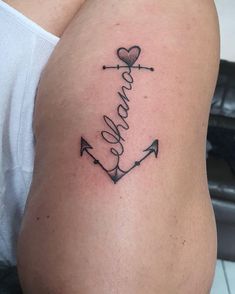 a woman with a tattoo on her stomach has an anchor and the word love written in cursive writing