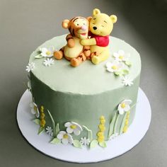 a winnie the pooh and tigger cake on a plate