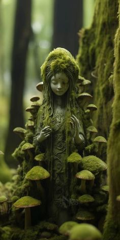 a moss covered statue in the middle of a forest with mushrooms growing all over it