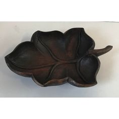 a wooden tray with a leaf design on it