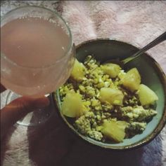 a bowl of food and a drink on a table