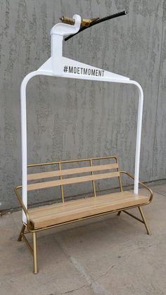 a bench with a toothbrush holder attached to it and the word moment written on it