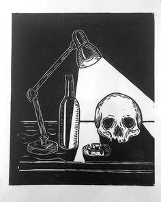 a black and white drawing of a skull sitting in front of a desk lamp