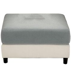 the footstool is made from fabric and has an upholstered pattern on it