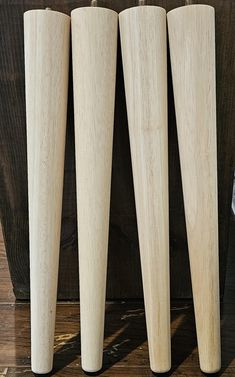 three wooden baseball bats lined up next to each other