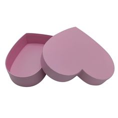 two pink heart shaped boxes sitting next to each other