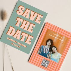 an orange and blue save the date card next to a couple's photo on a table