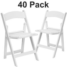 two white plastic folding chairs sitting next to each other