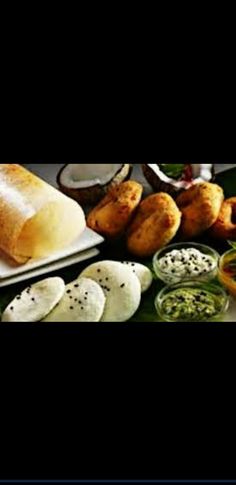 several different types of breads and condiments on a table