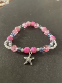 A fun and unique bracelet designed for a medium wrist. I make a different assortment of styles for each size, so your jewelry will be exclusive to you! Trendy Pink Bracelet With Faceted Beads, Starfish Charm Bracelet As Gift, Star-shaped Bracelet With Starfish Charm Gift, Casual Beaded Bracelets With Starfish Charm, Bohemian Starfish Bracelet As A Gift, Bohemian Starfish Bracelet For Gift, Bohemian Starfish Bracelet As Gift, Adjustable Stretch Bracelet With Star Charm As Gift, Casual Jewelry With Star Charm As Gift