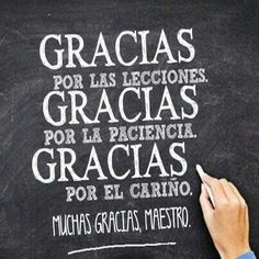 a person writing on a blackboard with spanish words written in white chalk and the word gracias