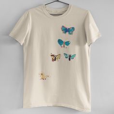 Vintage Natural Colorful Butterflies Tee Brand New! Our In House T-Shirts Are High Quality And Printed On Demand. This Tee Features Light Natural Tan Color, Vintage Print Of 5 Colorful Butterflies, Relaxed Unisex Fit, And 100% Cotton. Size S-Xl Available (Model Is Wearing A Size M) Cotton Multicolor Tops With Butterfly Print, Summer Cotton Shirt With Butterfly Print, Multicolor Crew Neck Top With Butterfly Print, Summer Cotton T-shirt With Butterfly Sleeves, Multicolor Casual T-shirt With Butterfly Print, Casual Multicolor Butterfly Print T-shirt, Multicolor Short Sleeve T-shirt With Butterfly Print, Multicolor Cotton T-shirt With Butterfly Print, Thrifting Manifestation