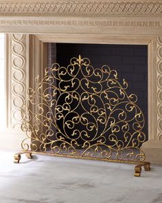 an ornate gold fireplace screen in the corner of a room