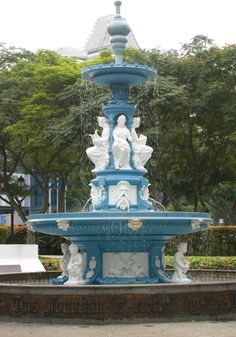 a blue and white fountain with statues on it