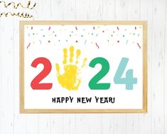 a happy new year card with a hand print on it and confetti sprinkles in the background