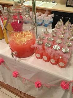 a table topped with lots of bottles filled with drinks