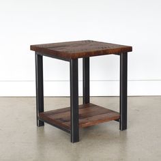 a square wooden table with metal legs and a shelf on the bottom that holds books