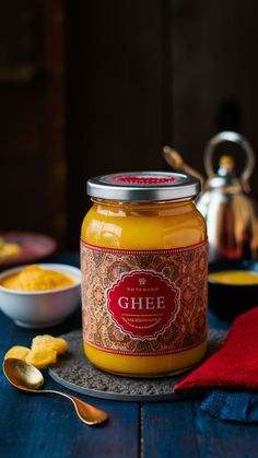 a jar of food sitting on top of a table next to a bowl and spoon