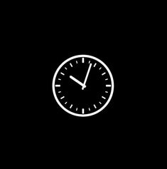 a black and white clock on a dark background