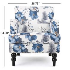 an upholstered chair with blue flowers on the back and arms, against a white background