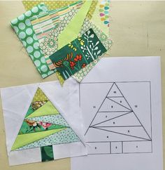 several pieces of paper are laid out on the table to make christmas tree quilts