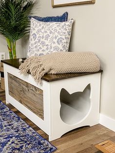 a wooden bench sitting on top of a hard wood floor next to a potted plant