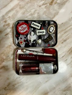 an open tin with some items in it