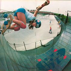 a person on a skateboard in mid air doing a trick at a skate park