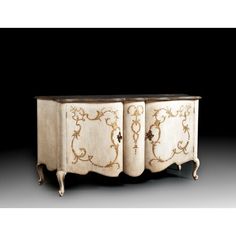 an ornately decorated cabinet with three doors and two drawers on the front, against a black background