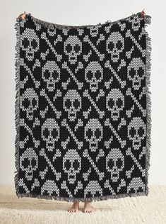 a black and white knitted blanket with skulls on it