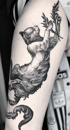 a woman's leg with a bear and flower tattoo design on it, in black and white