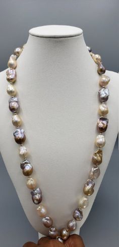 Baroque pearls have a non-spherical shape that gives them a unique appearance. No two baroque pearl necklaces will ever be the same. The white baroque pearl necklace choker is no exception, with a number of interestingly shaped pearls forming the 32-inch strand. The large baroque freshwater pearls have an AAA quality luster and Ivory rainbow hue body color. The baroque pearls are cultured in freshwater and have a thick nacre. The big baroque pearl necklace has a silver figure eight clasp. Pearls White Baroque Pearl Necklace, Pearl Necklace Choker, Silver Pearl Necklace, Baroque Pearl Necklace, Indian Wedding Jewelry, Bangle Set, Body Colour, Silver Pearls, Baroque Pearls