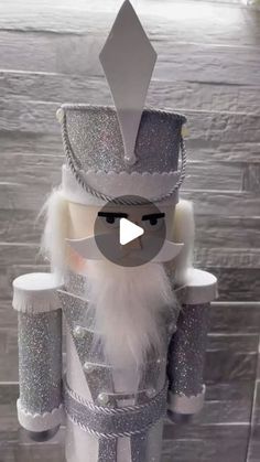 an image of a nutcracker made out of silver glitters and white fur