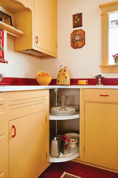 a kitchen with yellow cabinets and red counter tops is seen in this image from the inside