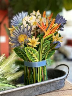 a vase filled with colorful flowers sitting on top of a table