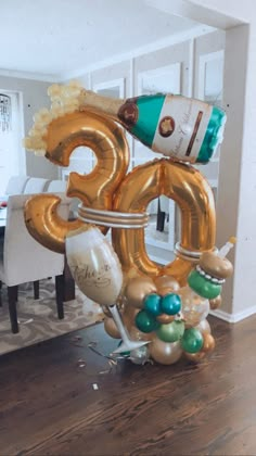 a balloon shaped like the number 50 with balloons attached to it in front of a dining room table