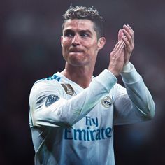 a man is applauding with his hands in the air while wearing a white uniform