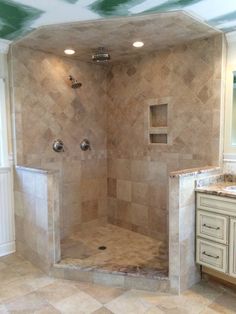 a walk in shower sitting inside of a bathroom