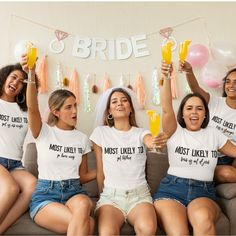 the bridesmaids are all wearing matching t - shirts and holding their champagne flutes