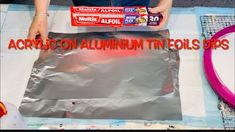 there is a woman that is making an aluminum foil bag with the words acrylon aluminum tinfoil tips on it