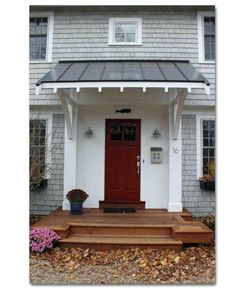 a white house with a red door and steps