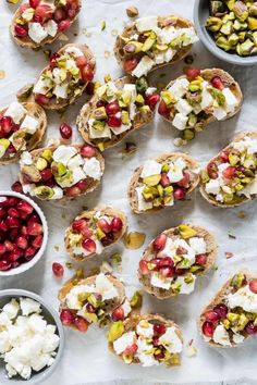 an assortment of appetizers with pomegranates, nuts and feta cheese