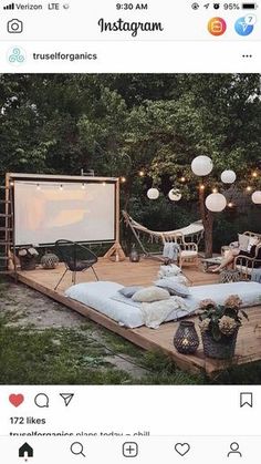 a screen shot of an outdoor movie in the backyard with string lights strung around it