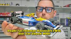 a man holding a toy car in front of his face with the words depi for nimes racers fw4 slot car check out