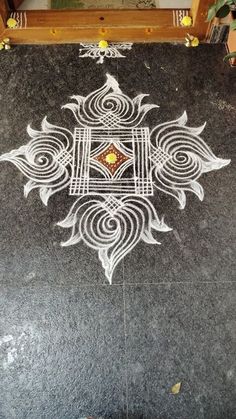 a black and white marble floor with an intricate design on it