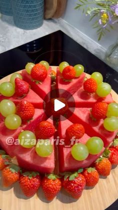 a watermelon and strawberries cake on a wooden platter