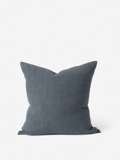 a dark gray pillow on a white background, with the back half turned to the side