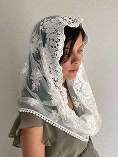 This soft embroidered floral lace veil is cut in an infinity shape. The veil edge incorporates intricate embroidery delicately designed with flowers throughout and a cotton trim.  This veil may be ordered in one of two colors (ivory or black). The women's veil measures approximately 46" around and 22.5" front to back.  Sewn-in metal snap comb clips may be requested free of charge. Each veil is sold separately and is handmade to order. Please review the Shipping policy for processing times and FR Mass Veil, Christian Veils, Cap Veil, Latin Mass, Chapel Veil, Lace Veil, Lace Veils, Intricate Embroidery, Ivory Lace